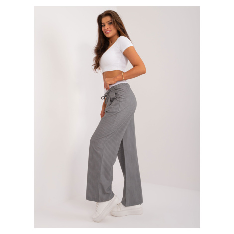 Grey fabric trousers with a white belt