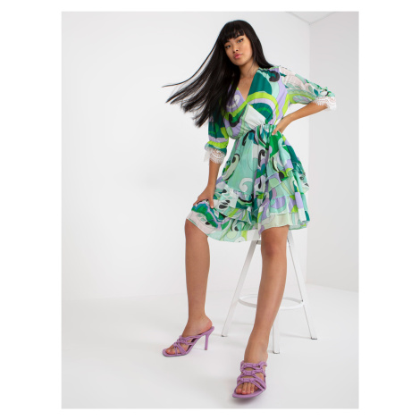 Green-purple wrap dress with frills and prints