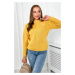 Diamond mustard sweater draped over the head