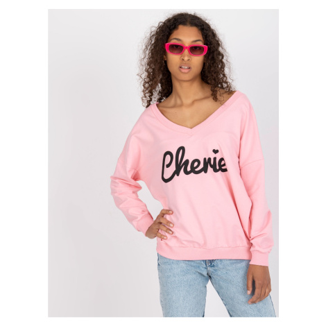 Light pink and black sweatshirt with an oversize print