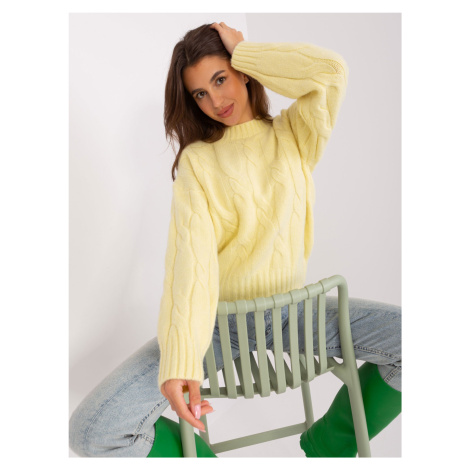 Light yellow sweater with cables and cuffs