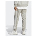 Adidas Teplákové nohavice Essentials French Terry Tapered Cuff 3-Stripes Joggers IC9407 Sivá Reg