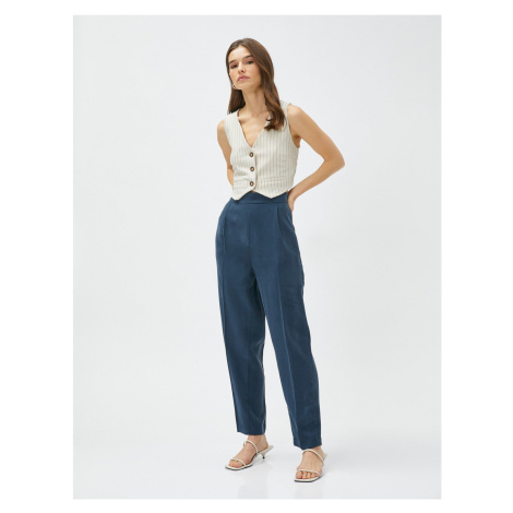 Koton Silky-textured pants with elastic waist and pockets.