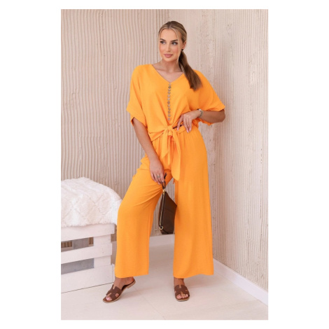 Set of bright orange blouse and trousers