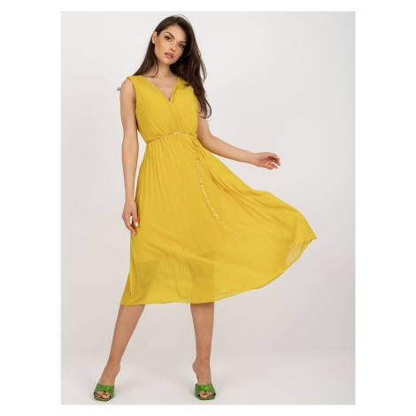 Dark yellow flowing dress with pleats