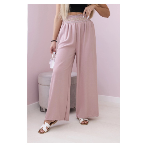 Trousers with a wide elastic waistband in dark pink colour