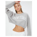 Koton The Slogan Printed Crop Sweatshirt is a relaxed fit with Long Sleeves.