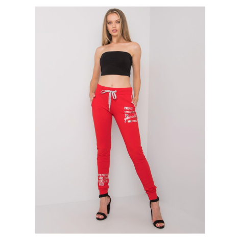 Women's red sweatpants with an inscription