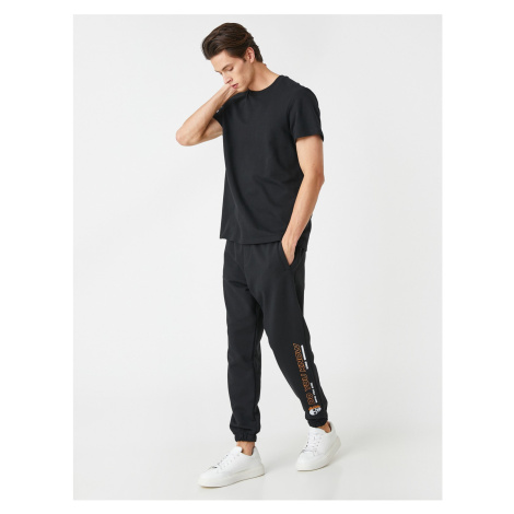 Koton Jogger Sweatpants with a skull print, pockets and a lace-up waist.